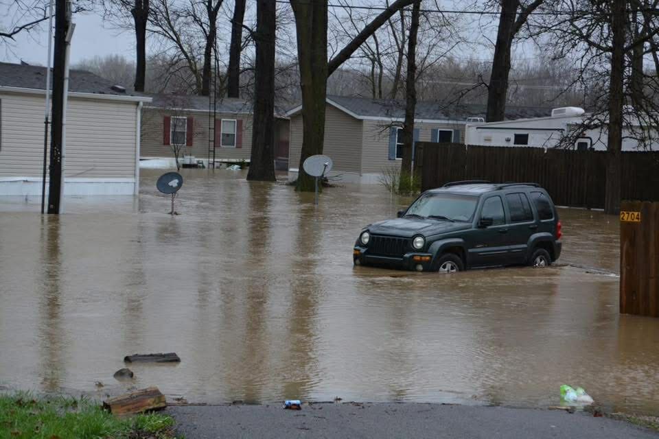 dark SUV stalled in flood with water almost up to windows